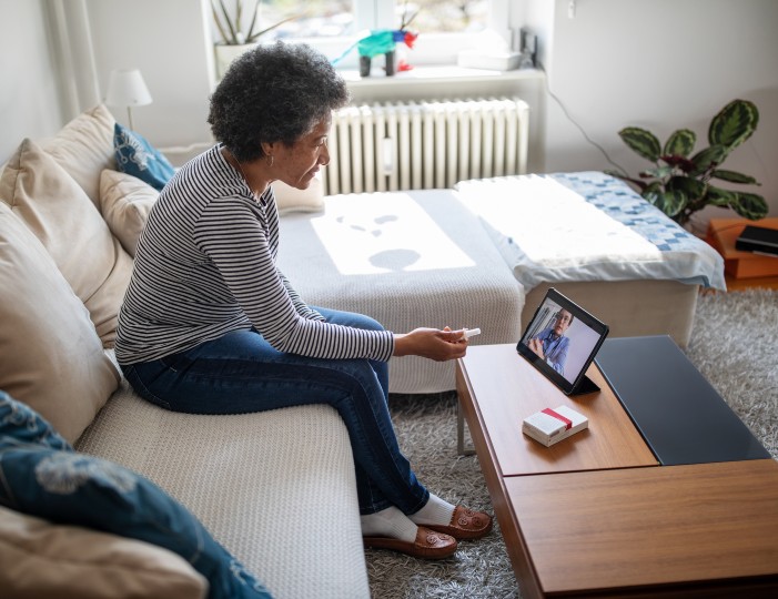 Woman talking to doctor from home over iPad