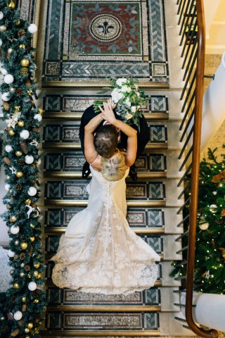 Wedding couple on the staircase with Christmas decoration