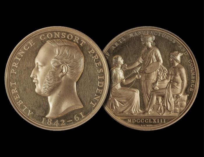 Two bronze medallions: left shows a profile of a bearded man labeled "Albert Prince Consort President 1842-61"; right depicts a standing figure and two seated figures with the text "Arts Manufactures Commerce MDCCGCLXIII.