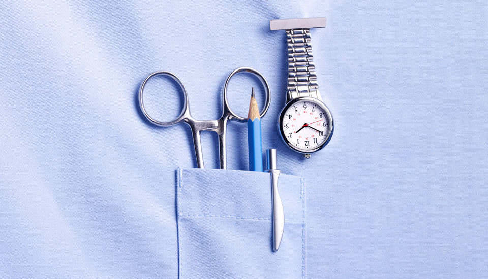 A light blue shirt with a pocket containing a pair of scissors, a pencil, and a pen. A silver nurse watch is clipped above the pocket, displaying the time.