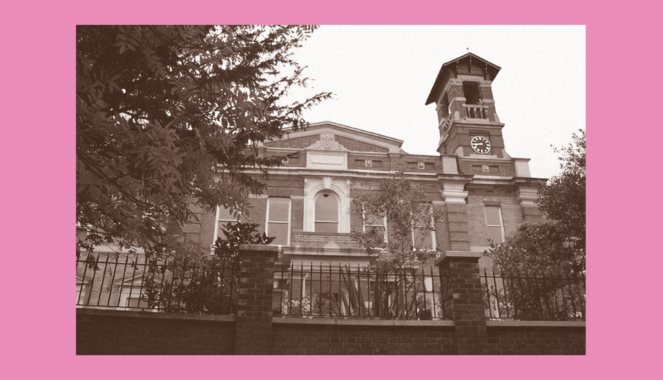 Sepia-toned image of a historic, brick courthouse with a clocktower, viewed from below. The building is framed by trees and a decorative fence, set against a solid pink background.