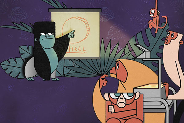 Cartoon monkeys gathered as one presents a drawing labeled "Wheel" on a flip chart. Other monkeys, some sitting and one on an overhead projector, appear interested. Background features large leaves, creating a jungle-like setting.