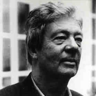 Black and white portrait of an older man with short, slightly tousled hair, wearing a collared shirt and jacket. He appears thoughtful, looking off to the side, with a neutral expression. Background shows blurred window panes.