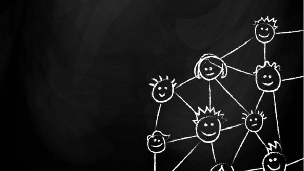 Chalk drawing on a blackboard depicts a network of interconnected smiling faces, connected by lines. The faces vary in size and hairstyle, symbolizing a sense of community and connection.