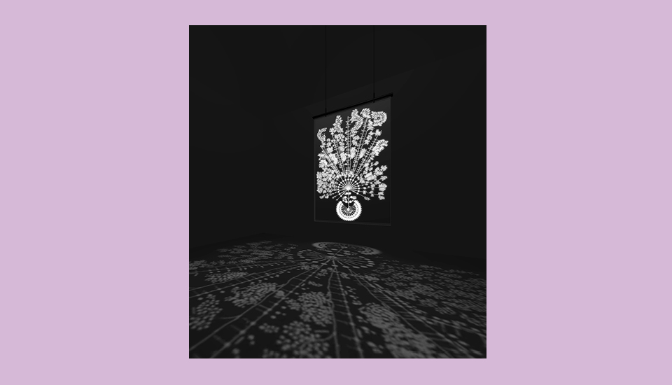 A black room features a suspended artwork with an intricate white design resembling flowers. The artwork casts a detailed shadow on the floor below, creating a mirrored floral pattern. The background is a soft purple.