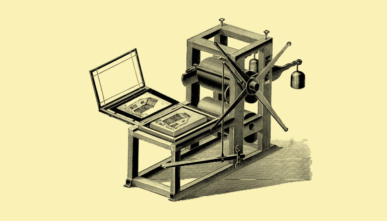 An old-fashioned printing press with large rollers, a crank handle, and a flat platform holding two illustrated pages on an open surface, shown against a plain light background.