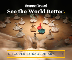 A group of whirling dervishes in flowing robes dance in a circle on a wooden floor. Text reads: "Steppes Travel - See the World Better." Below, a button says "Discover Extraordinary.