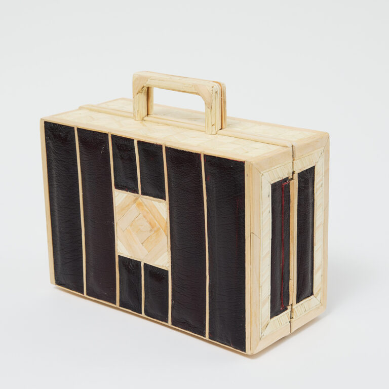 A rectangular briefcase made of light-colored wood and dark panels, with a handle on top and geometric patterns on its surface, displayed against a plain white background.