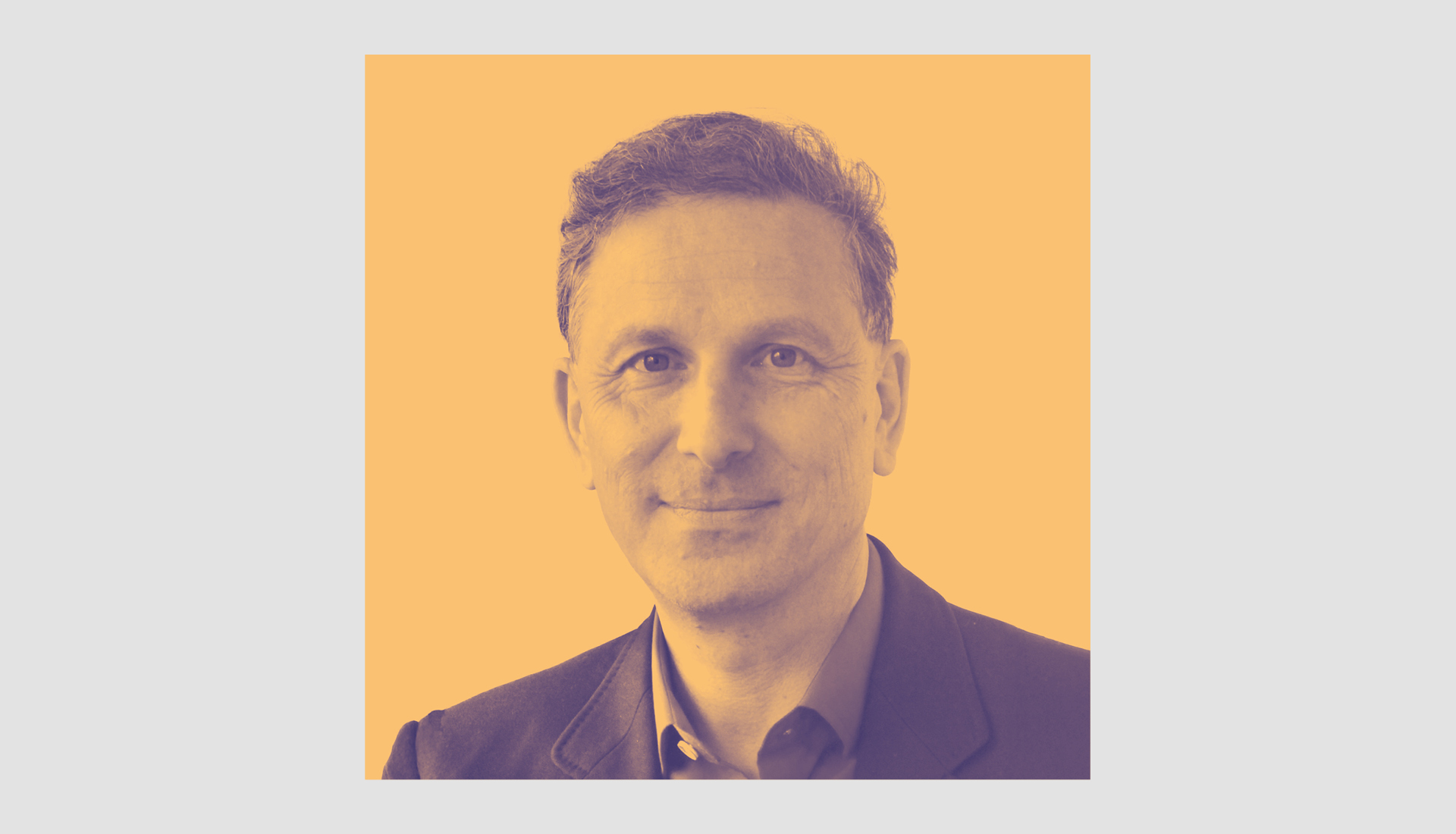 Portrait of Alexander Kohnstamma, a middle-aged man with short curly hair, wearing a dark jacket and collared shirt, smiling slightly. The image has a yellow and purple duotone effect with a light gray background.