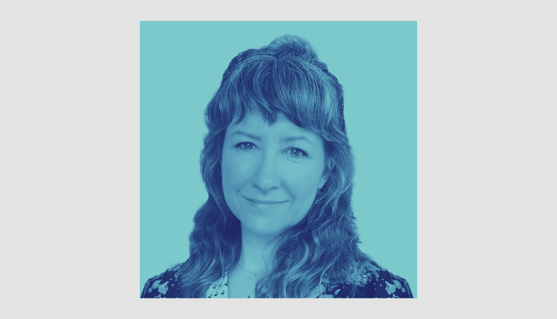 An image of Hildreth England with wavy hair smiling slightly, shown in a blue monochrome filter, facing forward against a light blue background.