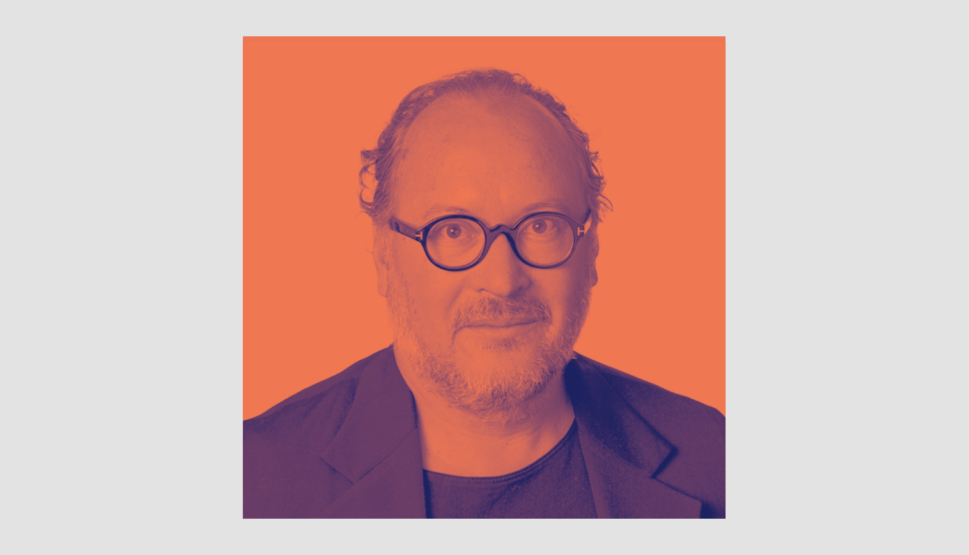 A man with glasses and short hair faces the camera, wearing a dark blazer over a shirt. The image has an orange and purple color filter applied.