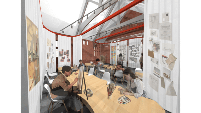 Interior view of an art studio with people painting and drawing at oval tables. The space has high ceilings with exposed beams, white walls covered in artwork, and large windows letting in natural light.