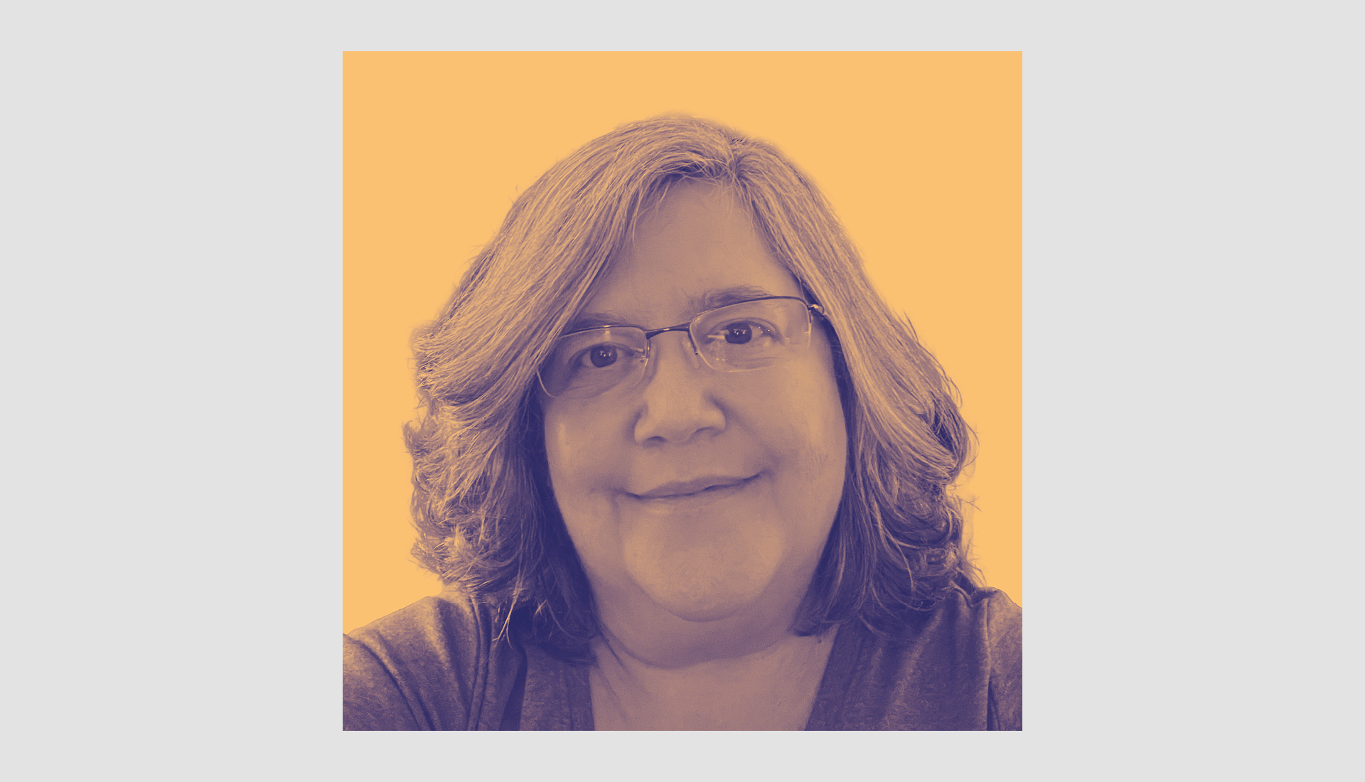 A middle-aged woman with shoulder-length wavy hair and glasses smiles softly; the image has a warm, orange-tinted filter and a light gray background.